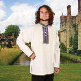 lightweight cotton folk shirt has button neck with embroidered trim around collar and placket and matching trim at cuffs and hem